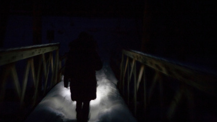 man walking in dark