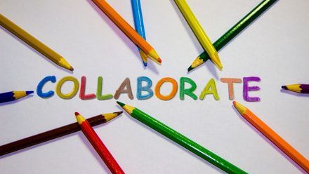 Coloured pencils surrounding the word collaborate