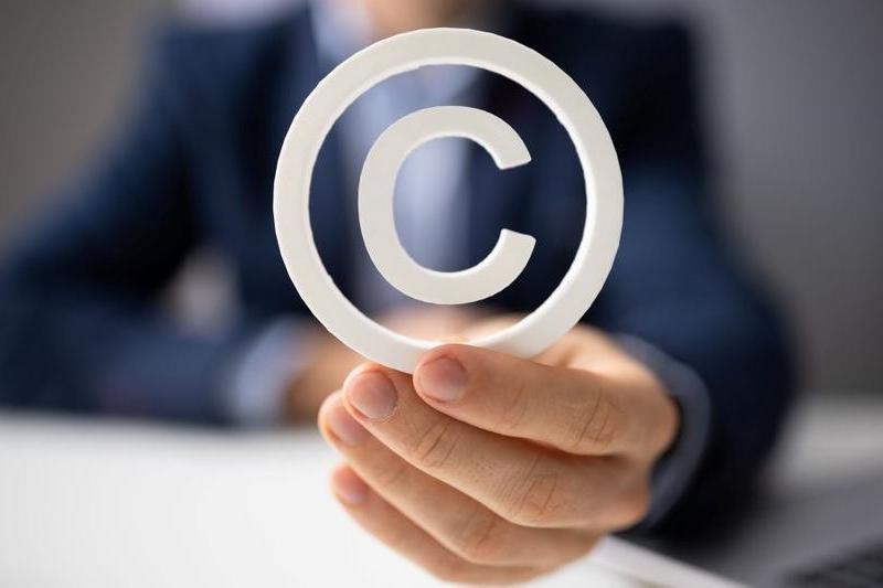 Image of person holding copyright symbol