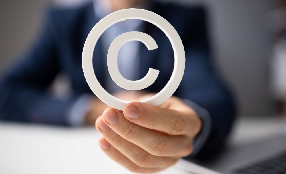 Image of person holding copyright symbol