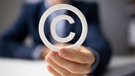 Image of person holding copyright symbol